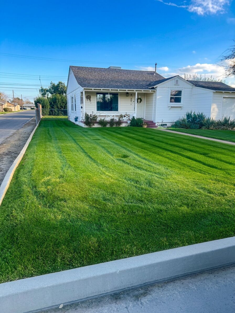 Charming white house front lawn freshly mowed with diagonal stripes